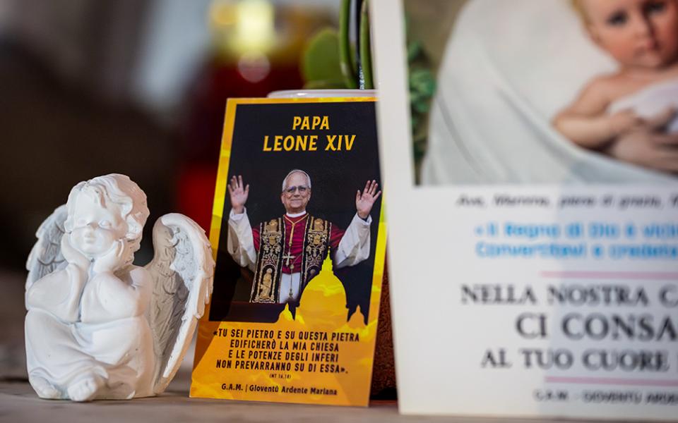 Devotional items can be seen at the foot of a statue of St. John Paul II outside of Rome's Gemelli hospital where Pope Leo XIV underwent surgery to remove a nodule in his lung Oct. 13, 2026. (CNS/Cristian Gennari)