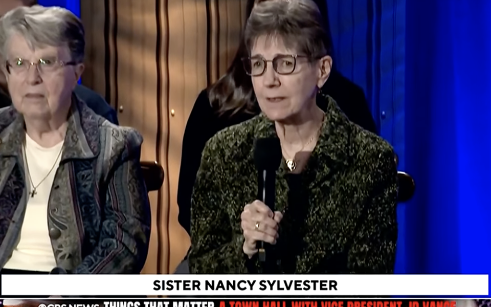 IHM Sr. Nancy Sylvester asks Vice President JD Vance a question about immigration enforcement at a town hall Oct. 17 in Detroit. (GSR screen capture)