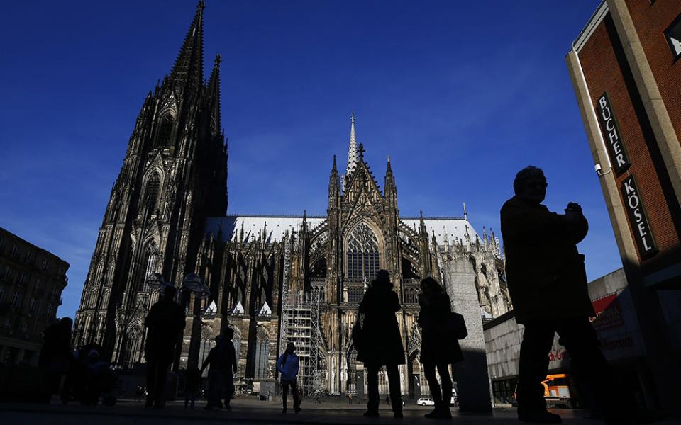 People are silhouetted against the Cologne Cathedral in Germany in 2016. (CNS/Reuters/Wolfgang Rattay)
