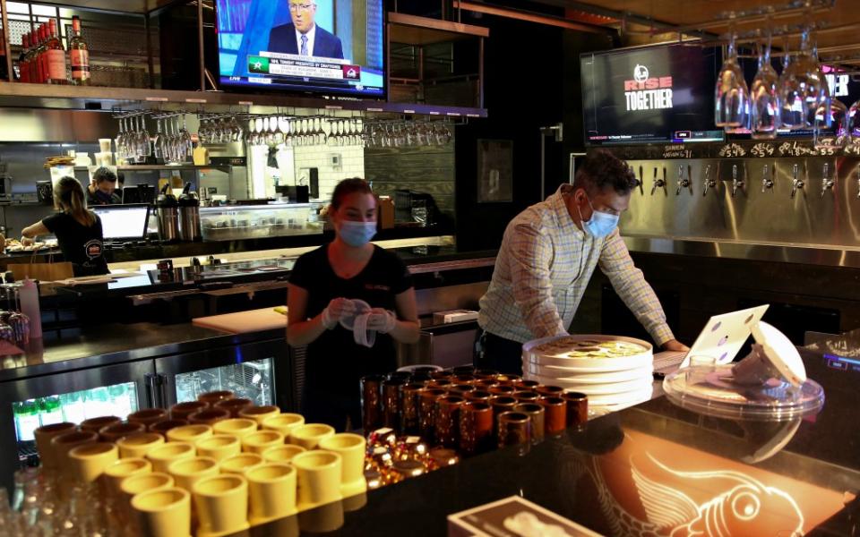 People in Miami work at a restaurant Aug. 31 during the coronavirus pandemic. (CNS/Reuters/Marco Bello)