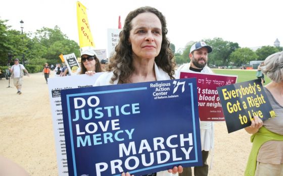Rabbi Jennie Rosenn, founder and CEO of Dayenu: A Jewish Call to Climate Action, takes part in a demonstration on the National Mall in Washington, D.C. (Courtesy of the Religious Action Center of Reform Judaism)