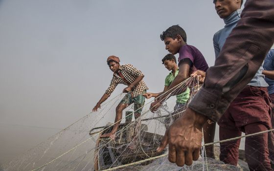 Fishermen cast their nets into the junction between the Meghna River and the Bay of Bengal off Monpura Island in Bangladesh.