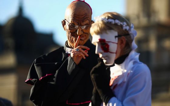 Activists dressed as clergymen and their victims protest the institutional church's protection of sex offenders in Krakow, Poland on Dec. 6, 2020. (ZUMA Press/NurPhoto/Beata Zawrze)  