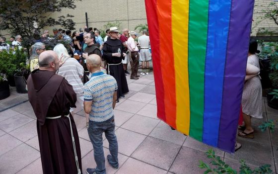 Franciscan friars of St. Francis of Assisi Church in New York City and members of the parish's LGBTQ ministry gather at a reception following an annual "Pre-Pride Festive Mass" June 26. (CNS/Gregory A. Shemitz)