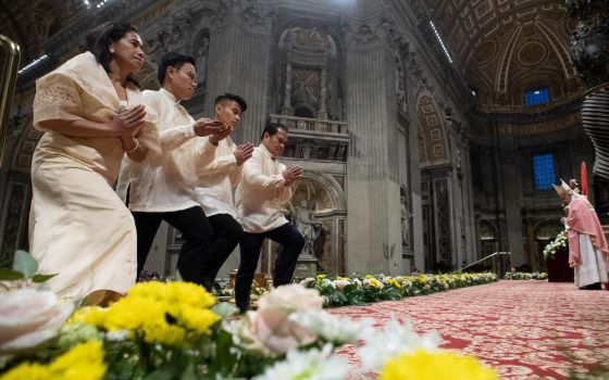 Members of the Filipino community in Rome approach the altar in the Vatican's St. Peter's Basilica during the offertory procession Dec. 15, 2019, as Pope Francis celebrates the first of the Simbang Gabi. (CNS/Vatican Media)