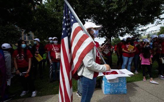 Migrant families and immigration advocates in Washington call for a pathway toward U.S. citizenship as they gather near Benjamin Banneker Park to march toward the U.S. Immigration and Customs Enforcement building Sept. 21. (CNS/Tyler Orsburn)
