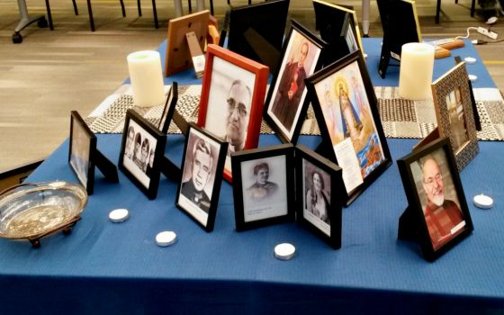 An ofrenda set up at the 2019 ACHTUS Colloquium at the University of Dayton, Ohio, June 2-5 displays photos of deceased ACHTUS members, loved ones and others. (NCR photo/Maria Benevento)