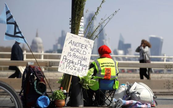 A demonstrator sits in the road during a climate protest organized by the environmental group Extinction Rebellion. The weeklong nationwide protest included this April 15, 2019, action on Waterloo Bridge in London. 