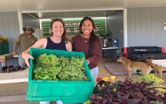 Erika L. Cuellar, operations director and co-founder and Isabella Andreoni, executive assistant, show off produce at ALMA Backyard Farms Compton, California, Feb. 3. The project was founded in 2013. (Melissa Cedillo)  