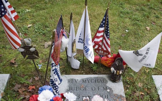 Flags and other items surround the grave where Franciscan Father Mychal F. Judge, a chaplain of the New York Fire Department, is buried at Holy Sepulchre Cemetery in Totowa, New Jersey.  Judge died in the Sept. 11, 2001, World Trade Center attacks. (CNS/O