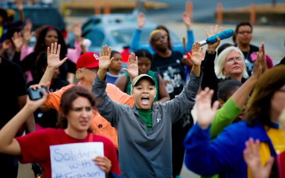 Protesters hold their hands in the air during a demonstration on Aug. 16, 2014, against the shooting death of Michael Brown in Ferguson, Missouri. (CNS/St. Louis Review/Lisa Johnston)