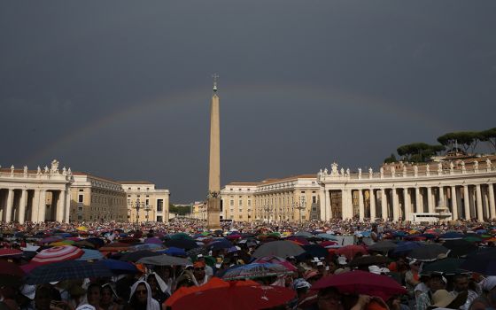 A rainbow is seen as Pope Francis attends a meeting with Catholic charismatics in St. Peter's Square July 3, 2015, at the Vatican. (CNS/Paul Haring)