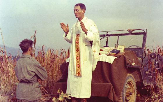 U.S. Army chaplain Father Emil Joseph Kapaun, who died May 23, 1951, in a North Korean prisoner-of-war camp, celebrates Mass from the hood of a jeep Oct. 7, 1950, in South Korea. (CNS/Courtesy of U.S. Army medic Raymond Skeehan)
