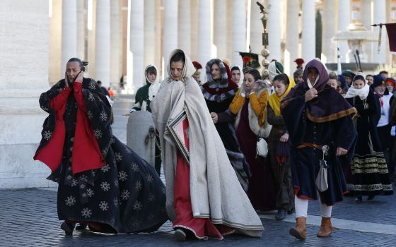 People in traditional attire endure cold weather during the annual parade marking the feast of the Epiphany in St. Peter's Square at the Vatican Jan. 6, 2017. (CNS photo/Paul Haring)