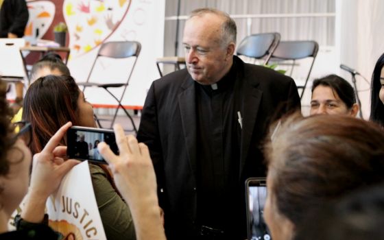 Bishop Robert McElroy of San Diego meets with Latino grassroots activists after his Feb. 18 talk at the U.S. Regional World Meeting of Popular Movements in Modesto, California. (CNS/Dennis Sadowski) 