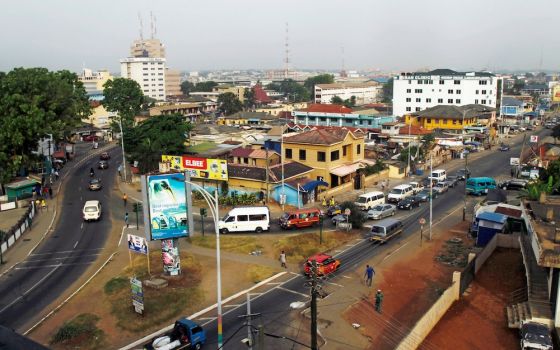 Cars and people travel through a business area in 2016 in Accra, Ghana. (CNS/Luc Gnago, Reuters)
