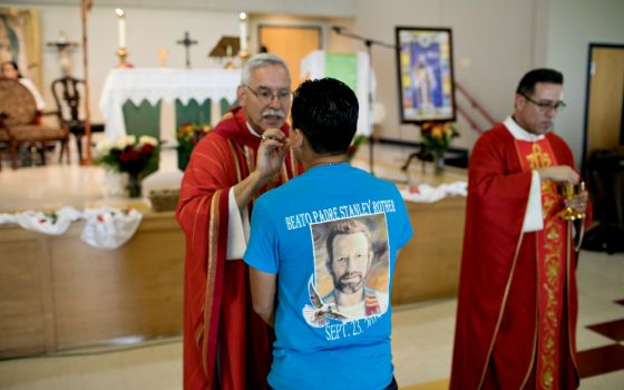 Bishop Anthony Taylor of Little Rock, Arkansas, gives Communion Sept. 24, 2017, to a member of a new Catholic community in Decatur named for Blessed Stanley Rother. (CNS/Courtesy of Catholic Extension/Rich Kalonick)