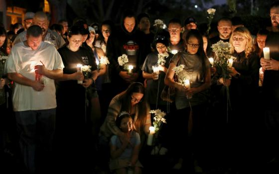 People attend a candlelight vigil Oct. 3 in memory of the victims of a mass shooting along the Las Vegas Strip. (CNS/Reuters/Mike Blake)