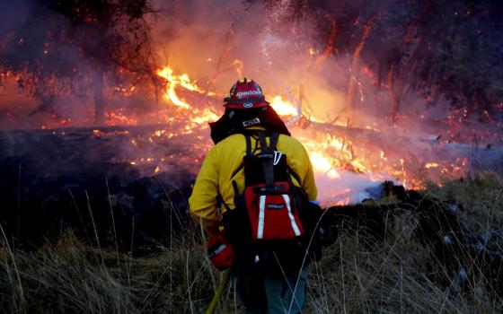 A firefighter battles a wildfire Oct. 14 near Santa Rosa, California. (CNS/Reuters/Jim Urquhart)