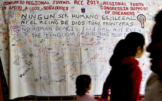 People walk in front of a banner supporting "Dreamers" during a daylong regional encuentro Oct. 28 at Herndon Middle School in Herndon, Virginia. (CNS/Tyler Orsburn) 