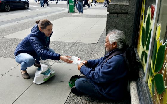 A volunteer with Catholic Street Missionaries interacts with a homeless man in early April 2017 in Vancouver, British Columbia. (CNS/Courtesy of Catholic Street Missionaries)