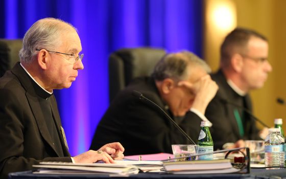 Archbishop Jose H. Gomez of Los Angeles, vice president of the U.S. Conference of Catholic Bishops, gives the opening prayer Nov. 13 at the bishops' fall general assembly in Baltimore. Also pictured are Cardinal Daniel N. DiNardo of Galveston-Houston, USC