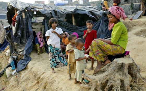 A Rohingya family sits outside their tent Nov. 20 at a refugee camp in Cox's Bazar, Bangladesh. (CNS/EPA/Abir Abdullah)