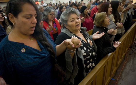 Worshippers recite the Lord's Prayer during a Mass celebrated in honor of the 100th anniversary of Our Lady of Guadalupe Church Dec. 9, 2017, in San Diego. The church was first founded to serve the recently arrived Mexican population in San Diego, and has