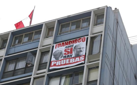 A protest banner that says in Spanish, "Yes, Francis, here there is proof," hangs outside the cathedral in Lima, Peru, Jan. 21. The banner protests Pope Francis' defense of Bishop Juan Barros of Osorno, Chile. (CNS/Paul Haring)