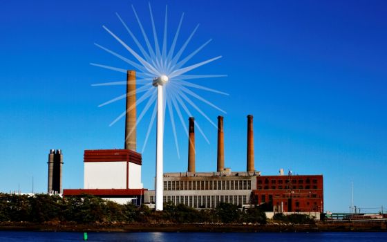 A wind turbine turns in front of a fossil fuel power plant in Charlestown, Mass., in 2013. (CNS/Reuters/Brian Snyder)