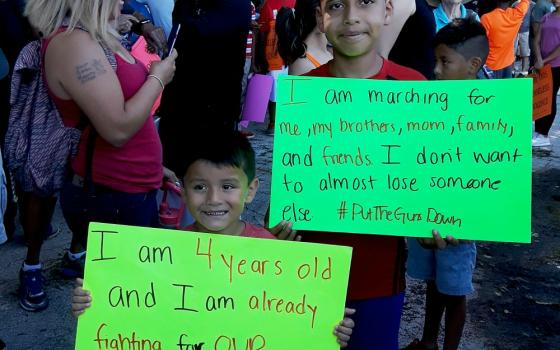 Two boys show their signs for a July 7 march against gun violence in Chicago. (Laurette Hasbrook)