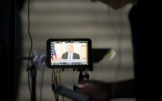 President Donald Trump is seen on a broadcast monitor outside the U.S. Supreme Court in Washington July 9. (CNS/Tyler Orsburn)