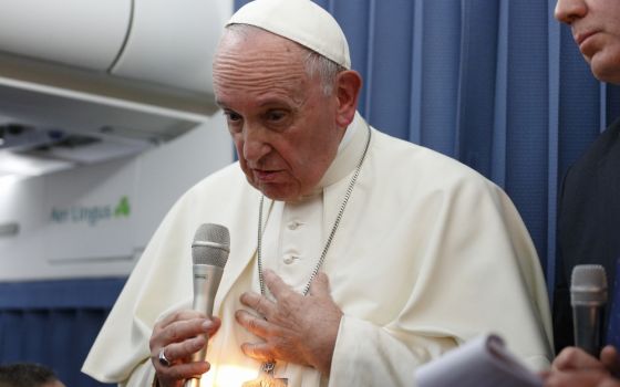 Pope Francis responds to a question from a reporter aboard his flight from Dublin to Rome Aug. 26. (CNS/Paul Haring)