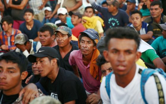 Central American migrants who are part of a caravan trying to reach the U.S. wait on a bridge Oct. 22 in Ciudad Hidalgo, Mexico. (CNS/Reuters/Edgard Garrido)