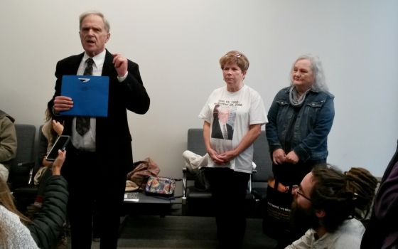Tom Fox speaks in the Kansas City, Missouri, courthouse lobby Dec. 7 ahead of his planned trial for trespassing on the National Security Campus. Also pictured are, from left, Debbie Penniston; Linda "Lu" Mountenay; and Jordan "Sunny" Hamrick. (NCR photo)