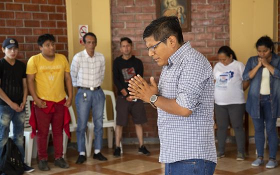 In December 2018, Abraham Luque, a catechist from the Scalabrinian Parish of Our Lady of the Perpetual Help, prays during at the Scalabrini welcome center for migrants in Lima, Peru. (CNS/Oscar Durand)