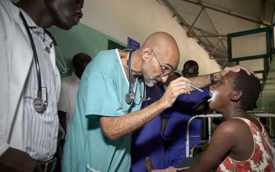 Dr. Tom Catena, a Catholic lay missionary from the United States, examines a patient during rounds in late April at the Mother of Mercy Hospital in Gidel, a village in the Nuba Mountains of Sudan. June 9, 2019 (CNS photo/Paul Jeffrey) 