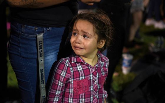 Serenity Lara cries during an Aug, 4, 2019, vigil, a day after a mass shooting at a Walmart store in El Paso, Texas. Pope Francis joined Catholic Church leaders expressing sorrow after back-to-back mass shootings in the United States left at least 31 dead