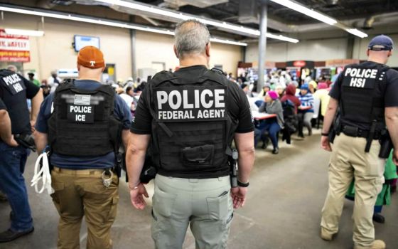 U.S. Immigration and Customs Enforcement officers look on after executing search warrants and making arrests Aug. 7 at an agricultural processing facility in Canton, Mississippi. (CNS/Immigration and Customs Enforcement handout via Reuters)