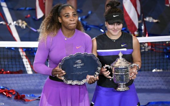 Serena Williams of the United States and Bianca Andreescu of Canada pose with the second-place and first-place trophies after Andreescu won the women's singles final on day thirteen of the U.S. Open tennis tournament Sept. 7, 2019 (CNS/USA TODAY Sports)