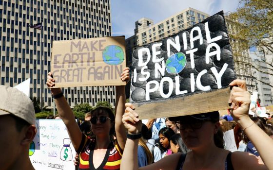 Young women hold signs while participating in the Global Climate Strike in New York City Sept. 20. (CNS/Gregory A. Shemitz)