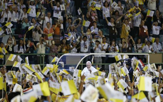 Pope Francis greets the crowd as he arrives to celebrate Mass in National Stadium in Bangkok Nov. 21, 2019. (CNS photo/Paul Haring)