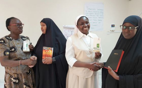 A Catholic woman and nun exchange holy books with Muslim women leaders Dec. 13, 2019, in Garissa, Kenya. (CNS/Courtesy of Fr. Nicholas Mutua)