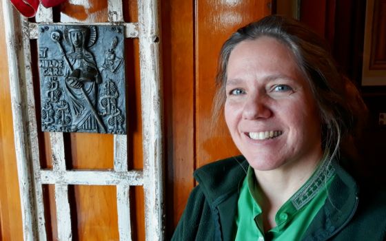 Shanon Sterringer is seen alongside an image of St. Hildegard of Bingen at Hildegard Haus, the church community she leads as a Roman Catholic woman priest in Fairport Harbor, Ohio. (Don Clemmer)