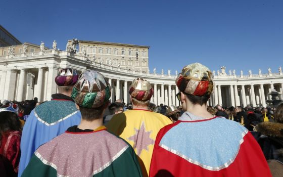 Children dressed as the Magi attend the Angelus led by Pope Francis from the window of his studio overlooking St. Peter's Square at the Vatican Jan. 1. (CNS/Paul Haring) 