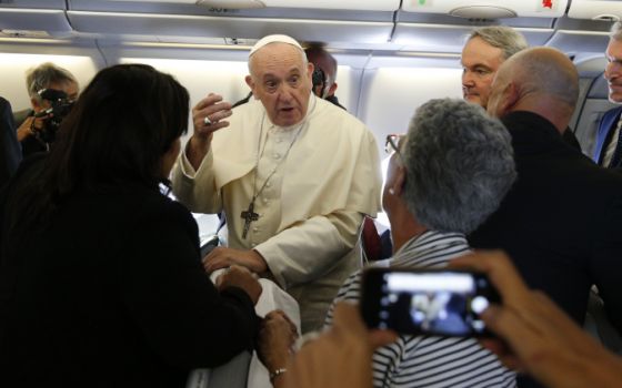 Pope Francis greets journalists aboard his flight from Rome to Maputo, Mozambique, Sept. 4, 2019. (CNS/Paul Haring)