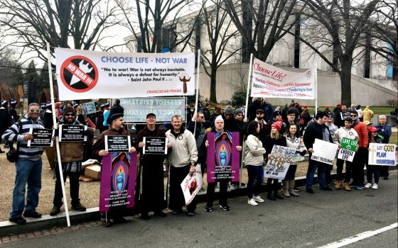 Franciscan friars and their supporters hold signs aloft outside of the security barrier where U.S. President Donald Trump spoke at the March for Life in Washington Jan. 24. (CNS/Courtesy of Lonnie Ellis)