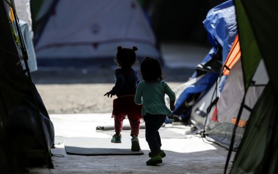 Migrant girls, who are asylum-seekers sent back to Mexico from the U.S. under the Trump administration's "Remain in Mexico" policy, are seen playing at a provisional campsite near the Rio Bravo in Matamoros, Mexico, Feb. 27, 2020. (CNS photo/Daniel Becerr