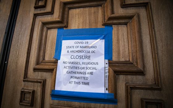 A sign on the door of St. Mary's Catholic Church in Landover Hills, Maryland, alerts the public there will be no Mass. (CNS/Chaz Muth)