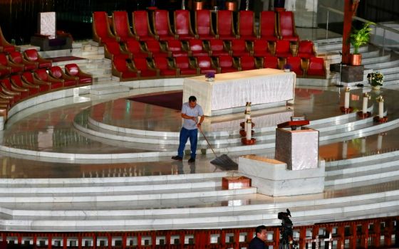 A worker cleans the floor before Cardinal Carlos Aguiar Retes of Mexico City celebrates an online Mass via YouTube and television at the Basilica of Our Lady of Guadalupe in Mexico City March 22. (CNS/Reuters/Henry Romero)
